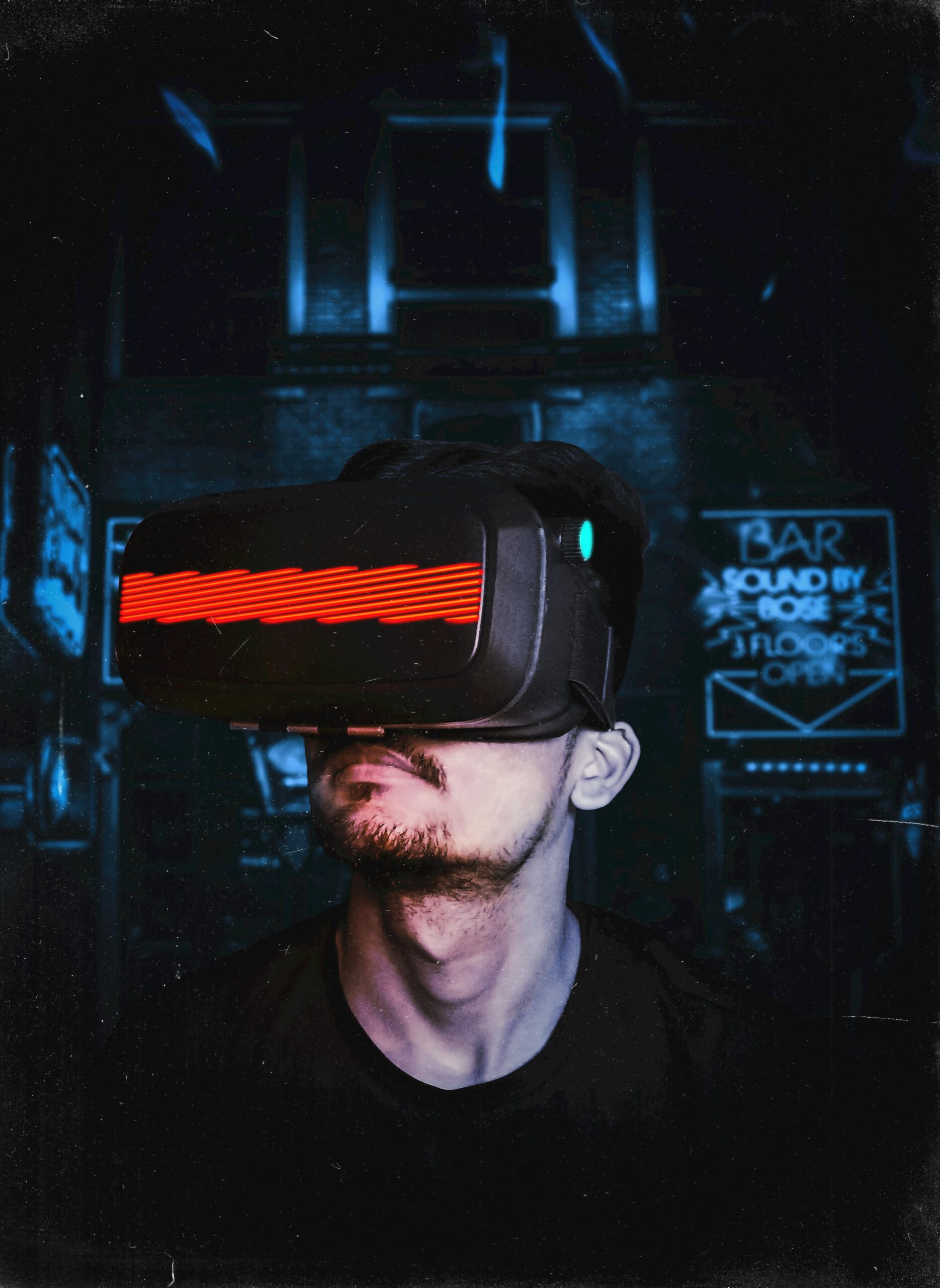 Young man immersed in a virtual reality experience using a VR headset, showcasing futuristic tech in a gaming environment.